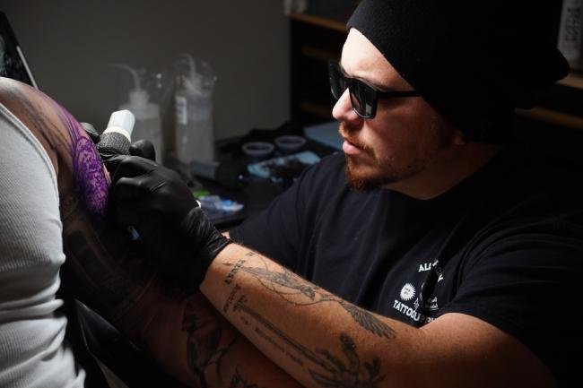 Yeins Gomez tattooing someone in Greenville South Carolina